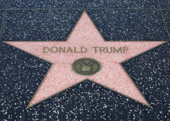 Los Angeles, California USA – May 30, 2015: Donald Trump's Hollywood Star on the Walk of Fame. The Hollywood Walk of Fame consists of more than 2,400 five-pointed brass stars embedded in the sidewalks along fifteen blocks of Hollywood Boulevard and three blocks of Vine Street in Hollywood, Los Angeles, California. The stars are permanent public monuments to achievement in the entertainment industry, bearing the names of a mix of actors, musicians, directors, producers, musical and theatrical groups, fictional characters, and others. The Walk of Fame receives 10 million visitors annually.