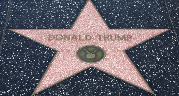 Los Angeles, California USA – May 30, 2015: Donald Trump's Hollywood Star on the Walk of Fame. The Hollywood Walk of Fame consists of more than 2,400 five-pointed brass stars embedded in the sidewalks along fifteen blocks of Hollywood Boulevard and three blocks of Vine Street in Hollywood, Los Angeles, California. The stars are permanent public monuments to achievement in the entertainment industry, bearing the names of a mix of actors, musicians, directors, producers, musical and theatrical groups, fictional characters, and others. The Walk of Fame receives 10 million visitors annually.