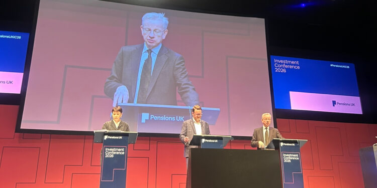 Caroline Lucas and Michael Gove (right) on stage